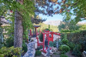 a garden with a pathway and a house at Au printemps Japonais in Pierre-Châtel +24 photos