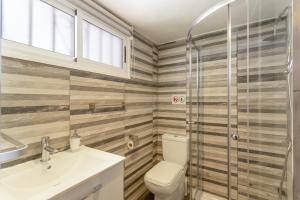 a bathroom with a toilet and a sink and a shower at Estudio Yumbo Playa Del Ingles in San Bartolomé +12 photos