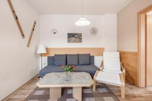 a living room with a blue couch and a table at Ferienwohnung Ufert in Meißen