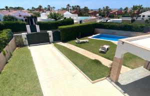 a view of a yard with a swimming pool at Villa los Tres Menorca in Cala en Bosc