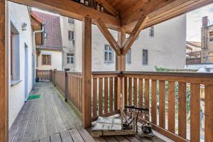 a wooden porch with a wooden deck at Ferienwohnung Ufert in Meißen