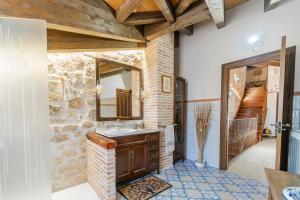a stone bathroom with a sink and a mirror at El Rincón de Hornuez in Moral +30 photos