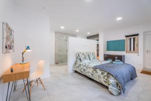 a bedroom with a bed and a desk at Bonanova 20 in Palma de Mallorca