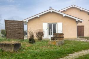 a house with a grass yard in front of it at Gite du maine in Langon