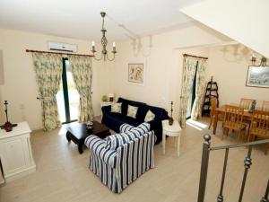 a living room with a couch and a table at Sami Beach Villas Nefeli in Karavomylos