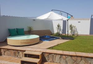 a hot tub sitting on top of a wooden deck at Villa Bea ii in San Bartolomé