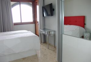 a bedroom with a bed and a window and a mirror at Villa Bea ii in San Bartolomé +37 photos
