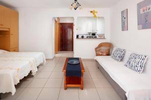 a living room with two beds and a couch at Estudio Bloque 84 in Torrox +19 photos