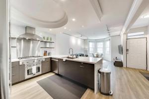 a large white kitchen with a sink and a stove at 3BR recently renovated SOMA flat in San Francisco +17 photos