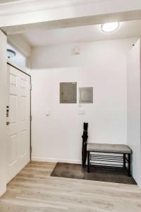 a room with a bench on a white wall at 3BR recently renovated SOMA flat in San Francisco