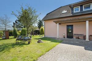 a house with a cart in the yard at Ferienwohnung Lüssow in Lüssow