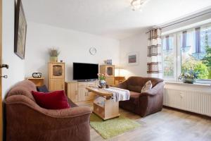 a living room with two chairs and a tv at Ferienwohnung Lüssow in Lüssow