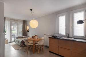 a kitchen and dining room with a table and a bed at Blueyes House Tuscany in Artimino +17 photos