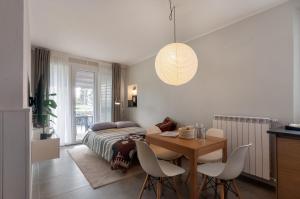 a bedroom with a bed and a table and chairs at Blueyes House Tuscany in Artimino