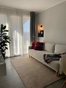 a living room with a couch and a large window at Blueyes House Tuscany in Artimino