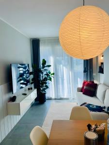 a living room with a white couch and a table at Blueyes House Tuscany in Artimino