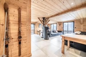 a large room with wooden walls and a living room at Martonne - haut Roca immobilier in Châtel