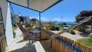 a hammock on the balcony of a house at Syros Mandala Studio in Ano Syros
