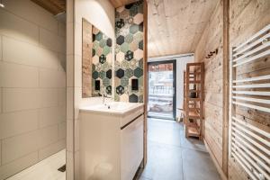 a kitchen with a sink and a wall with tiles at Martonne - haut Roca immobilier in Châtel +28 photos