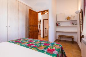 a bedroom with a bed with a colorful blanket at Finca Na Palada in Artá +22 photos