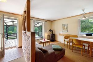 a living room with a table and a dining room at Krüseliner Mühle - Bungalows in Krüselin