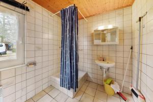 a bathroom with a shower and a sink at Bungalow 4 - Kimbucht in Reichendorf +16 photos
