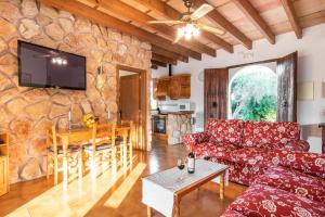 a living room with a couch and a table at Finca Pollentia in Alcudia
