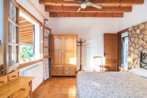 a bedroom with a bed and a wooden ceiling at Finca Pollentia in Alcudia +25 photos