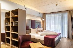 a bedroom with a bed and a book shelf at Ferienwohnung Hirsch-Loge in Pflach