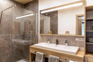 a bathroom with a sink and a shower at Ferienwohnung Hirsch-Loge in Pflach +21 photos