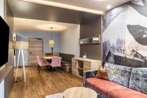 a living room with a couch and a table at Ferienwohnung Hirsch-Loge in Pflach