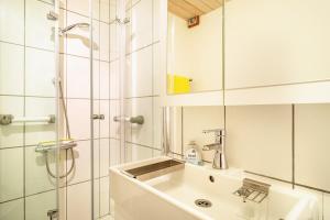 a white bathroom with a sink and a shower at Marie in Weiler-Simmerberg +19 photos