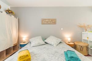 a bedroom with a bed with two lamps and two towels at La Dolce Vita in Lambesc +10 photos