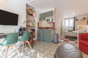a small kitchen and living room with a red couch at La Dolce Vita in Lambesc