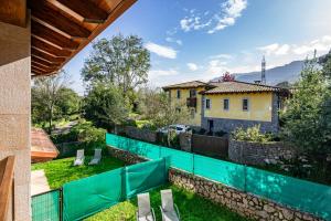 a view from the backyard of a house with a green fence at 4 Terraza - Antilles sin jardin in Llanes