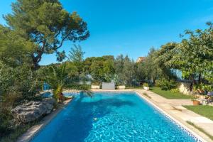a swimming pool in a yard with trees at La Dolce Vita in Lambesc