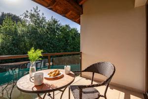a table and two chairs on a balcony at 4 Terraza - Antilles sin jardin in Llanes
