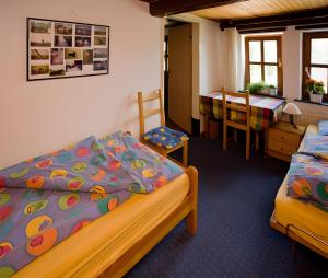 a bedroom with two beds and a table and chairs at Ferienwohnungen Appelhof in Pellworm