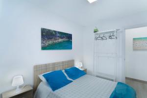 a bedroom with a bed with blue pillows at Villa Monica in Agüimes