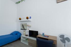 a living room with a blue couch and a tv at Villa Monica in Agüimes