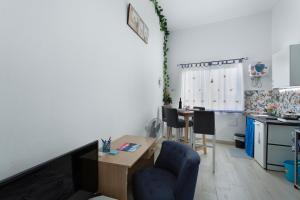 a kitchen with a table and a blue chair at Villa Monica in Agüimes +16 photos