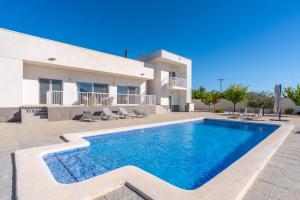 a villa with a swimming pool in front of a house at Macisvenda relax in Macisbenda