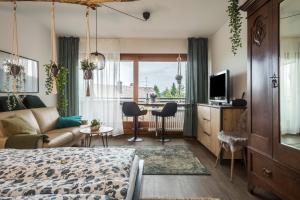 a bedroom with a bed and a living room at Heimelig im Hirschen App 240 in Schönwald
