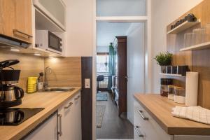 a kitchen with white cabinets and a counter top at Heimelig im Hirschen App 240 in Schönwald