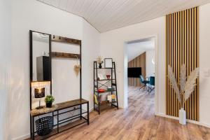a living room with a mirror and a table at Dasensteinblick in Kappelrodeck