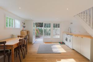 a kitchen with a table and a dining room at Ker Lotig in Locquirec +28 photos
