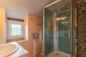 a bathroom with a glass shower and a sink at O’bord Du Gave in Saucède +38 photos
