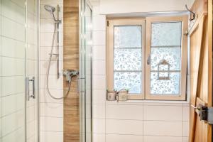 a bathroom with a shower and a window at Eifelyeti Ferienwohnung mit Sauna in Ellscheid +20 photos