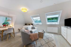 a living room with a chair and a table at Appartement Skagen in Glücksburg