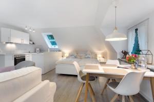 a bedroom and living room with a bed and a table at Appartement Skagen in Glücksburg